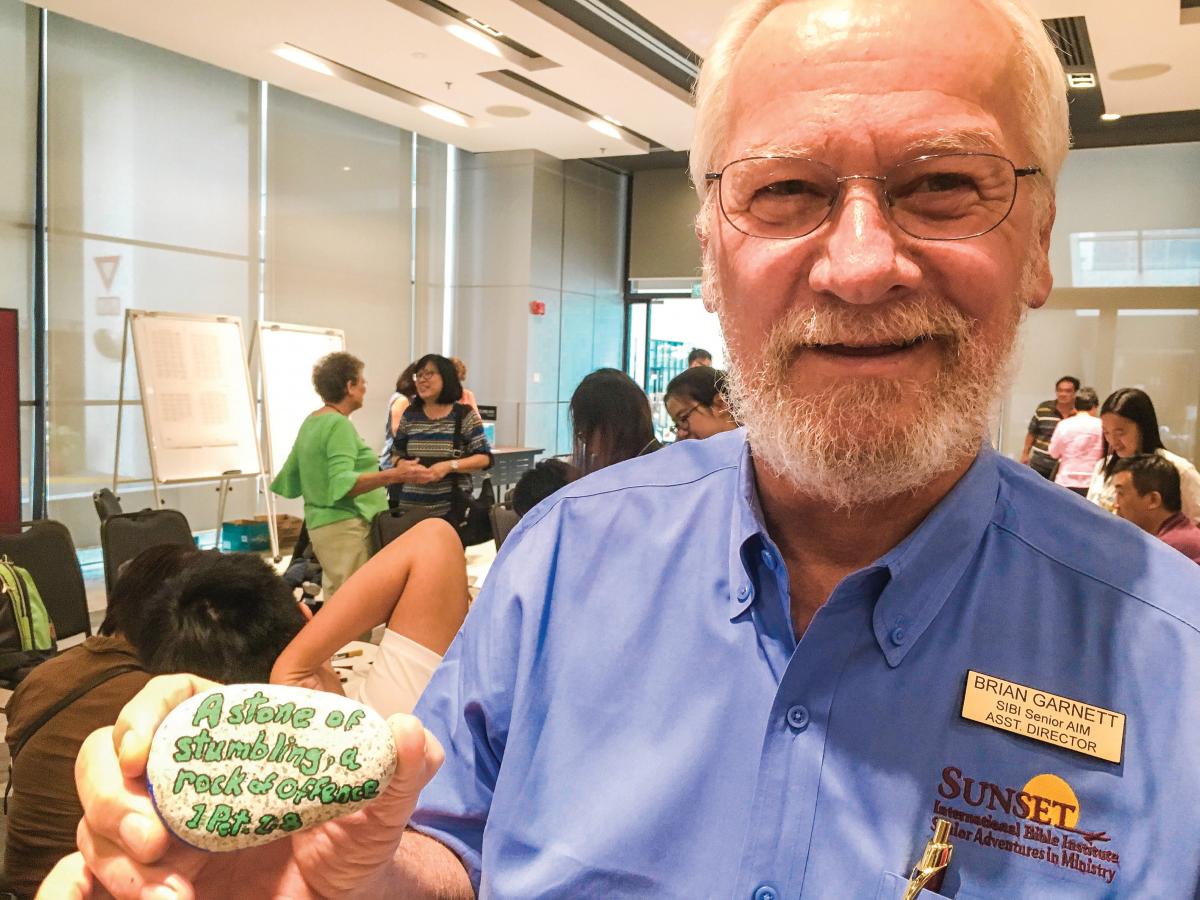 Brian Garnett with a painted rock from a retreat activity