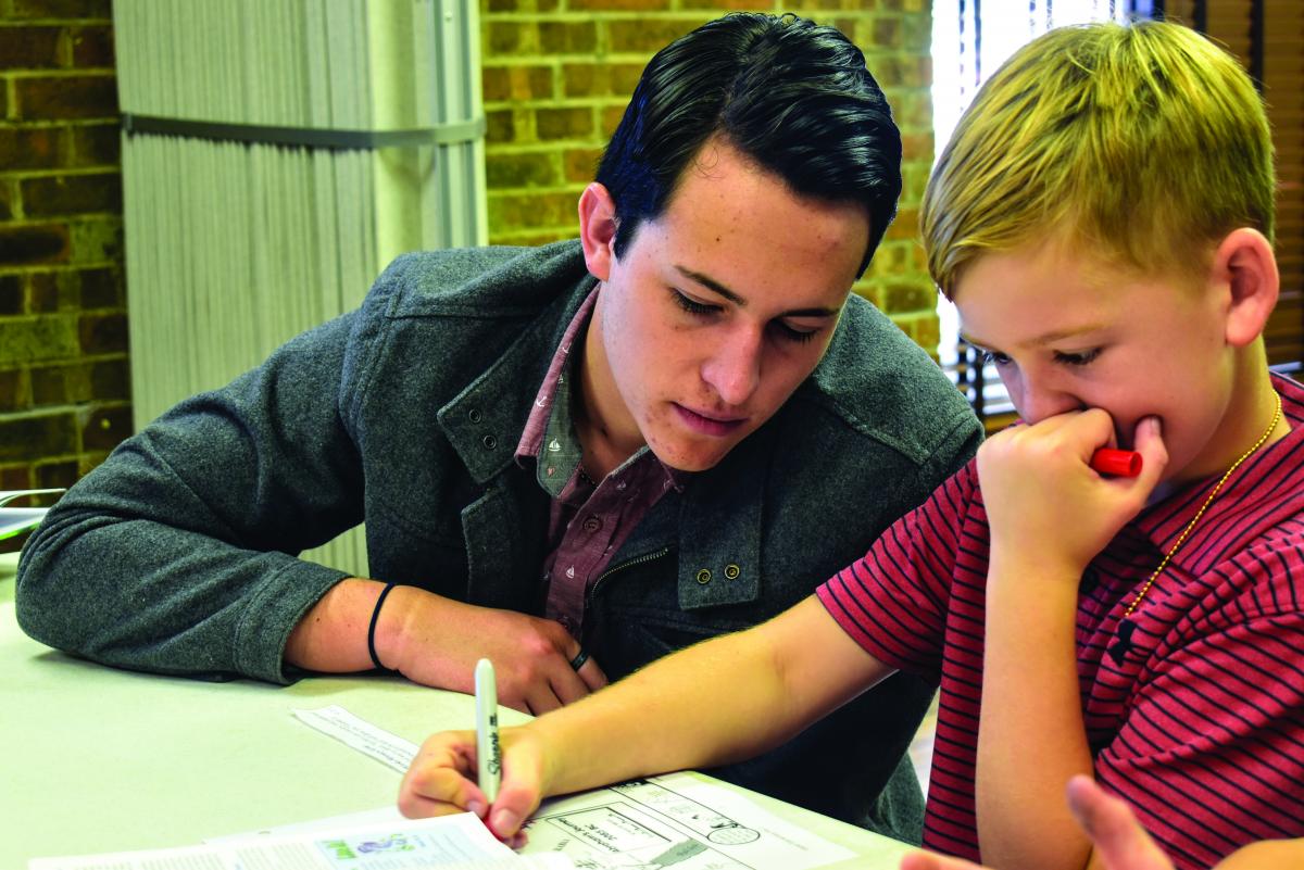 Mason Gary works with a young man during his time at an area church