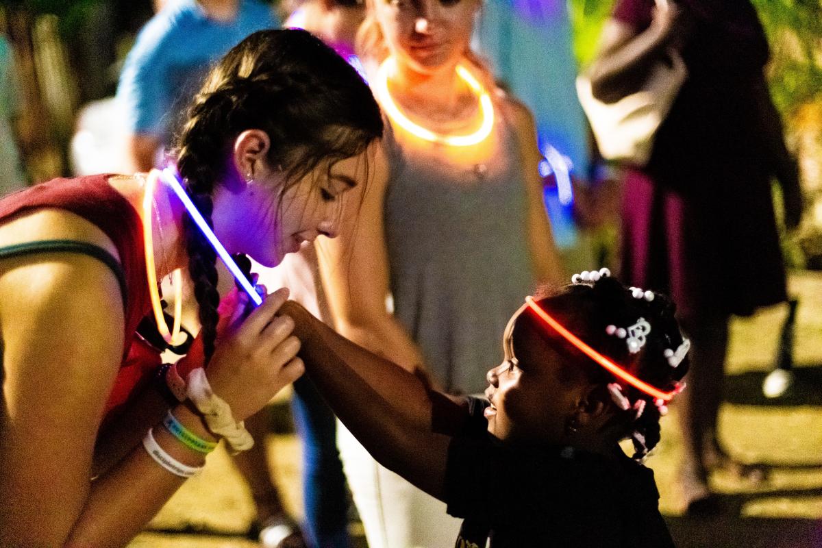 handing out glow sticks during street preaching at night.