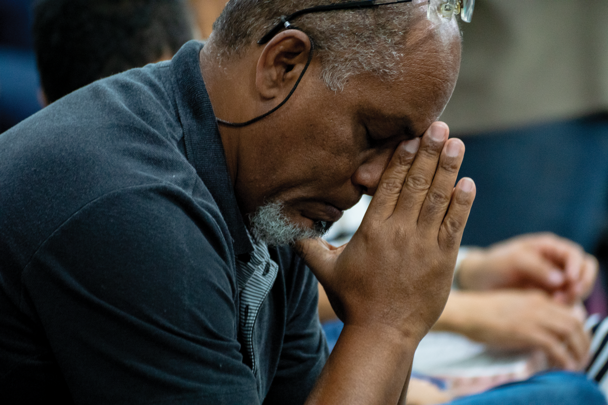 A brother in Brazil prays during communion