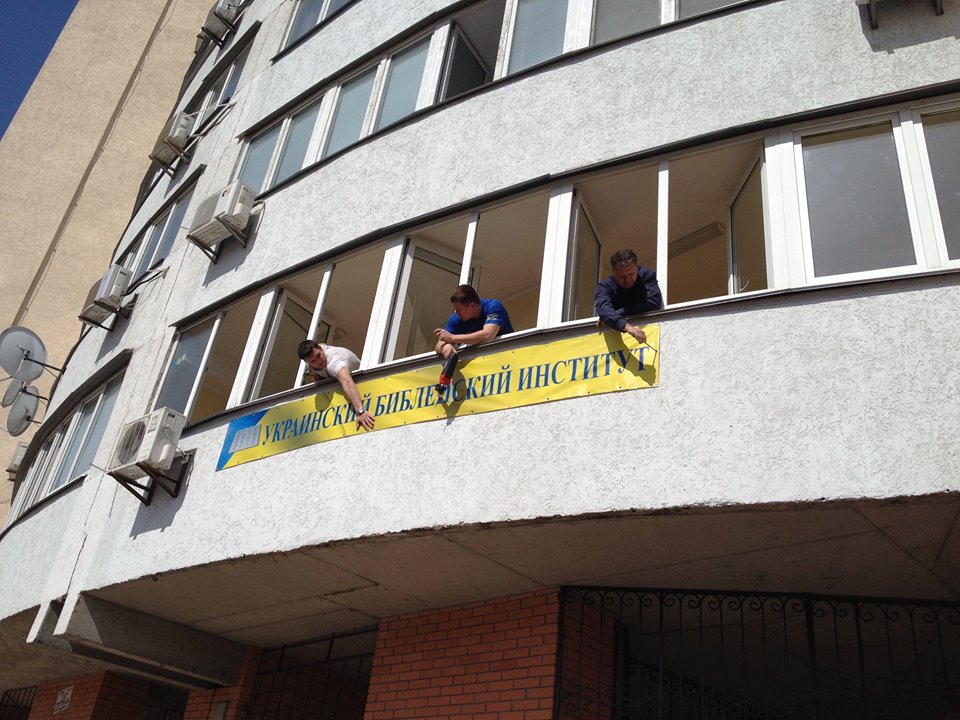 Hanging the sign for the school