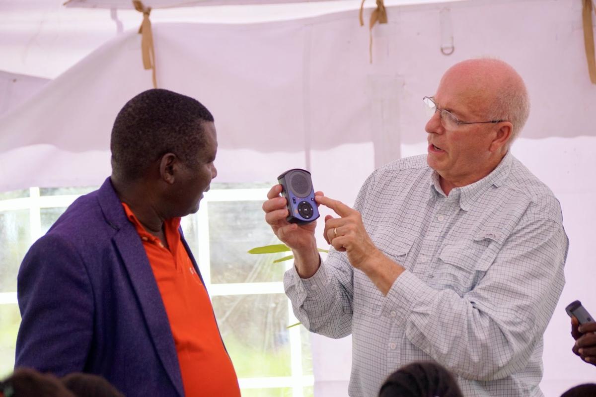 Richard Karima showing his solar player to Doug