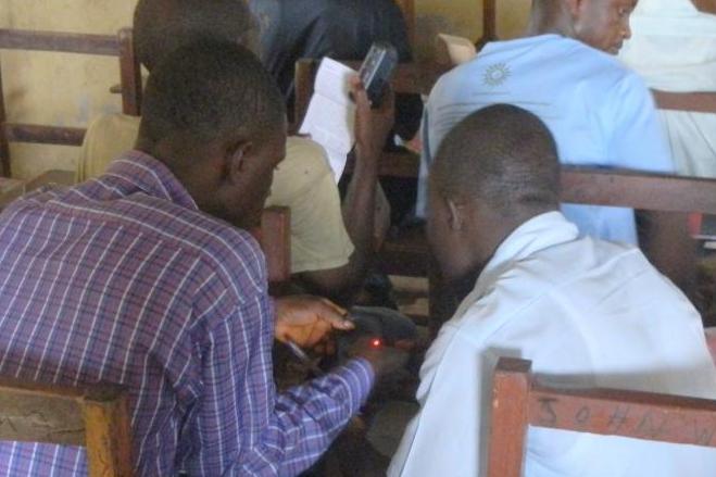 Students in Liberia listening to the solar player