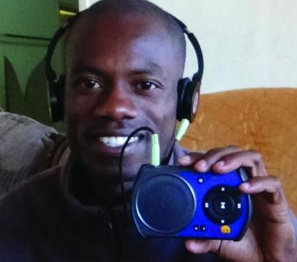 A young preacher in Zimbabwe excited to receive his solar-powered audio player