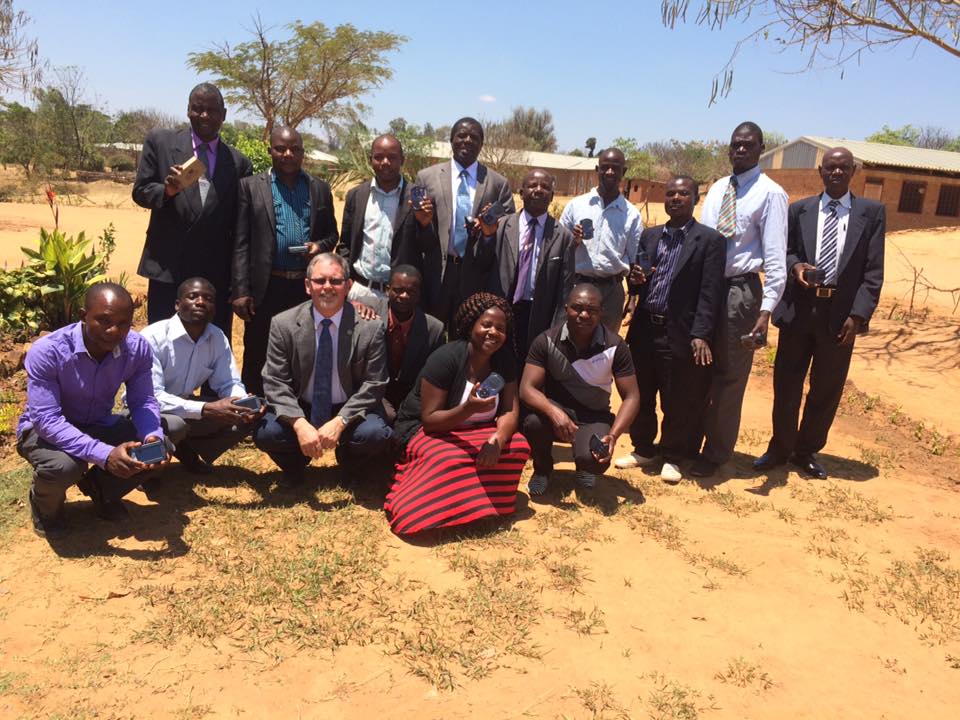 Tim Burow with a group in Malawi that received solar players